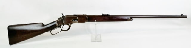 1882 Model 1873 Winchester Rifle .32 Cal: Antique Winchester Model 1873 Rifle in .32 Caliber Manufactured in 1882. Lever action rifle with carved walnut stock with steel receiver, barrel and trigger assembly. Good condition with surface wear,