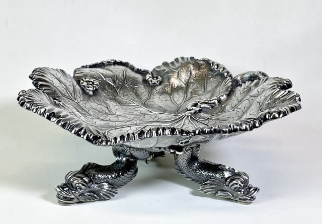 English Sterling Silver Centerpiece, Garrard & Co: 20th C. English Sterling Silver Centerpiece. Stylized leaf form bowl with tripod dolphin form feet. Hand chased decoration with hallmarks for "Garrard & Co Ltd" London, crown jeweler until 2007. Excel