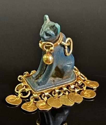 22K Gold Embellished Carved Egyptian Stone Pendant: Ancient Egyptian Carved Stone Bastet Amulet, Embellished with 22K Gold. Seated Cat Goddess "Bastet" with 22K yellow gold collar and findings, gold base with hallmarked gold disks. Good condition, meas