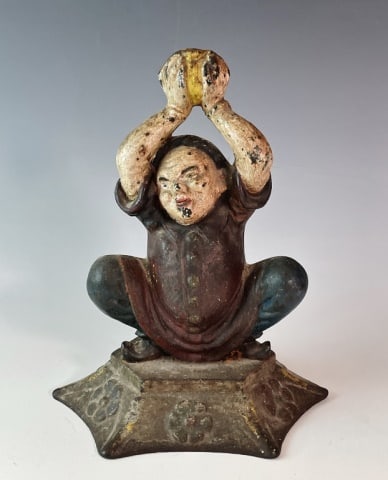 Antique Cast Iron Figural Doorstop: Antique Cast Iron Figural Doorstop. Seated Asian figure with arms aloft, period painted surfaces. Good condition, measures: 9" H.
