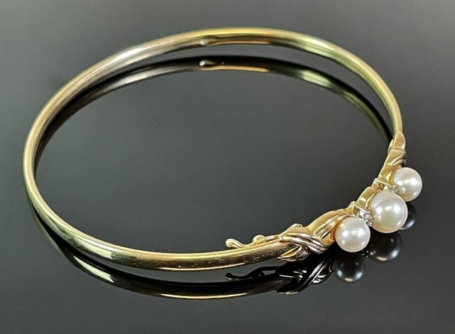 Ladies 14K Gold and Pearl Bracelet: Vintage Ladies 14K Gold and Pearl Bangle Bracelet. Crafted in 14K yellow gold, set with three saltwater cultured pearls. Excellent condition, assembled weight:4.2 dwts., 6.6 g.