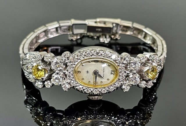 Antique Art Deco 14K Gold Diamond Watch, Hamilton: Antique Art Deco 14K Gold and Diamond Ladies Wristwatch, Hamilton. Crafted in 14K white gold set with one hundred forty-five round cut diamonds of varying size, including two canary yellow diamonds of