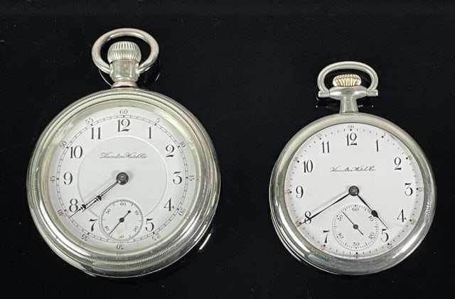 17J Pocket Watches, Hamilton (2pc): Two Antique 17J Pocket Watches, Signed "Hamilton Watch Co": (1) Model 1, grade 972, 17 Jewel nickeled movement, top wind open face screwback case pocket watch with engraved locomotive on back plate, 1
