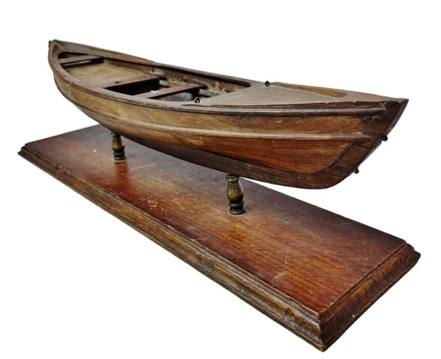 Antique Scratch Built Wooden Dory Model: Antique Scratch Built Wooden Dory Model. Carved wooden multi-piece construction with interior bench seats. Model in period stand, excellent condition, measures: 5.75"H x 19" W x 4.75" D.