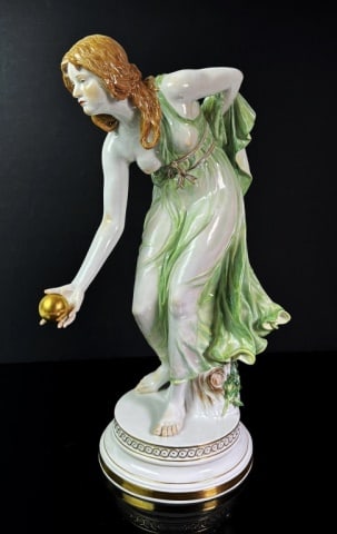 German Hand Decorated Porcelain Figure, Meissen: Hand Decorated German Porcelain Sculpture, Signed with Crossed Swords Mark (Meissen). Neoclassical Figure of a Female Bowling with gilt embellishment. Excellent condition, measures: 15" H x 9.5" W x 6