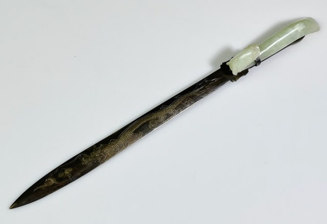 Chinese Qing Dynasty Jade Buckle Letter Opener: Chinese Qing Dynasty Carved Jade Buckle Letter Opener. Bronze blade with engraved dragon and floral decoration, Handle with carved jade buckle. Good condition, measures: 11.25" L.