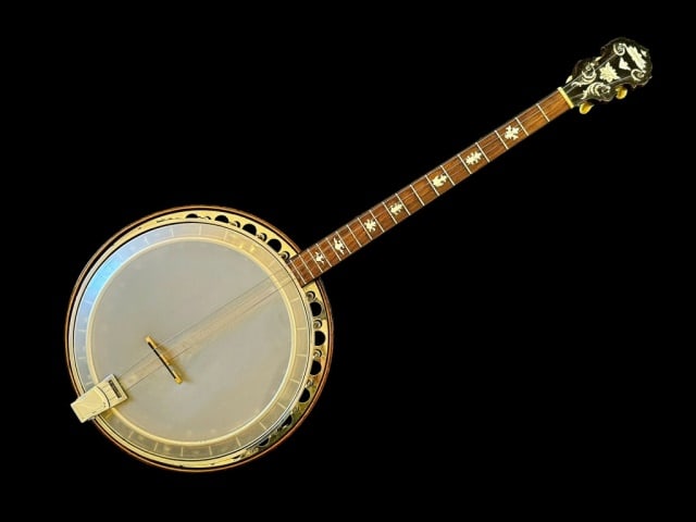 1930's Tenor Banjo, Paramount Style B: 1930's Tenor Banjo, Signed "PARAMOUNT Wm. L. Lange Style B" Four string banjo, headstock with mother of pearl logo and scroll decoration, mother of pearl inlayed fret board. Nickeled reticulated rim a