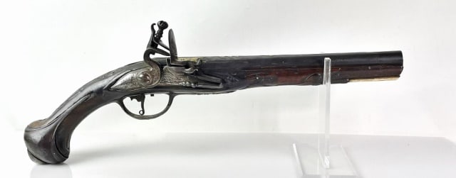 Early 18th C. Continental Flintlock Pistol: Circa 1710 - 1730 Continental Flintlock Pistol. Artfully carved walnut stock with steel furniture, barrel decorated with gold embellishment, lock with hand chased scroll foliate decoration. Trigger gu