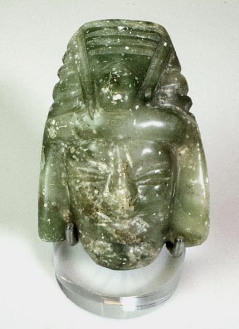 Pre Columbia Mayan Carved Jade Pendant: Pre Columbian Mayan Carved Jade Pendant. Carved visage with headdress of a god or priest, surfaces with evidence of ground burial. Good condition with losses, measures: 4" H x 2.75" W x 1.25" D.