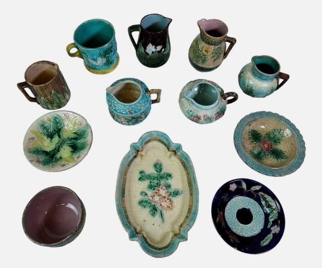 Collection of Antique Majolica (12pc): Collection of Twelve Antique Majolica Pieces: (6) Creamers with diverse decoration and form, (1) Cup, (3) Bowls, (1) Small plate, (1) Tray. Good condition largest measures: 1.5" H x 9" W x 6" D.