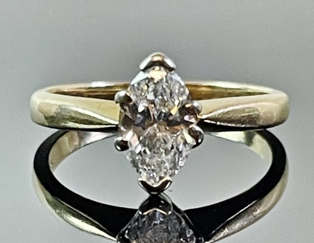 14K Gold Diamond Solitaire Engagement Ring: Vintage 14K Gold Diamond Solitaire Engagement Ring. Ring crafted of 14K yellow gold with prong set marquis cut diamond evaluated as SI3, J-K color and approximately .8 cts. Total assembled weight: 1.8