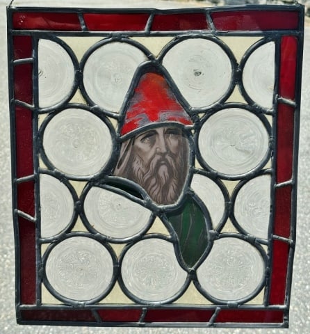 Antique German Leaded Glass Window: Antique German Leaded Glass Window. Window hand made with pontiled glass panes and central stained glass panel of hand painted gnome figure. Good condition, measures: 15" H x 13" W.
