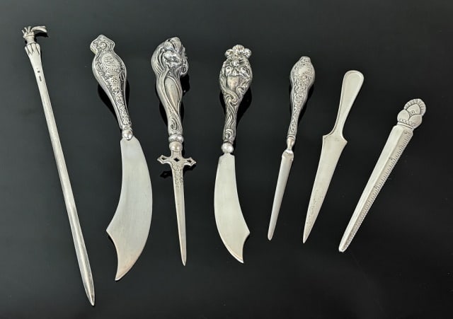 Antique Sterling Silver Letter Openers (7pc): Collection of Seven Sterling Silver Letter Openers. Diverse styles, solid silver and silver handled with steel blades. Good condition, largest measures: 9.5" H.