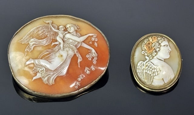 Two Antique Italian Cameo Pins (2pc): Two Italian Neoclassical Shell Cameo Pins. Hand carved with classical themes with metal bezels and pin backs. Good condition, larger measures: 2.25" H x 2.5" W.