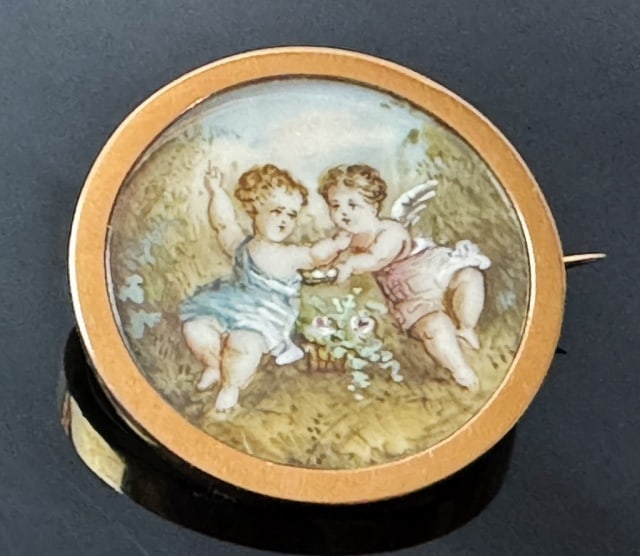 14K Gold Hand Painted Neoclassical Brooch: Antique 14K Gold Brooch with Hand Painted Neoclassical Scene. 14K yellow gold frame and pin back with hand painted scene of two cherubs. Measures: 1" D, Total assembled weight:3.3 dwts, 5.2g