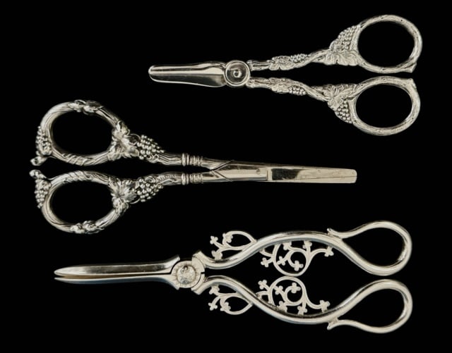 Antique Sterling Silver Grape Shears (3pc): Collection of Three Antique Sterling and Continental Silver Grape Shears. Stylized Neoclassical form with repousse decoration. Good condition, largest measures: 6.75" L, Combined weight: 6.3 Ozt.