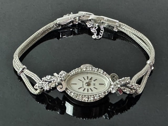 Art Deco 14K Gold Diamond Watch, Hamilton: Antique Art Deco 14K Gold and Diamond Ladies Wristwatch. 14K white gold case set with twenty-four well matched round cut diamonds, band gold filled. Total assembled weight: 8.0 dwts, 12.6 g.