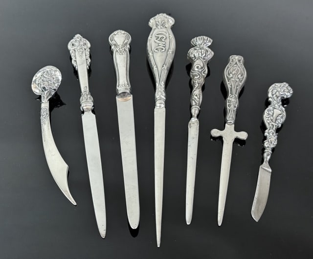 Sterling Silver Handled Letter Openers (7pc): Collection of Seven Antique Sterling Silver Handled Letter Openers. Diverse sizes, design and decoration. Good condition, largest measures: 9"