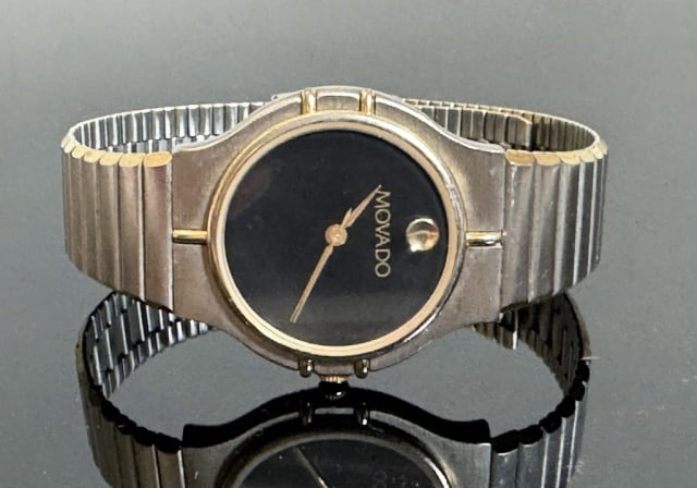 Vintage Swiss Watch, Movado: Vintage Swiss Wristwatch, Signed "MOVADO". Stainless steel case and band with black museum style face and Swiss quartz movement. Excellent condition, case measures: 1.2" D.