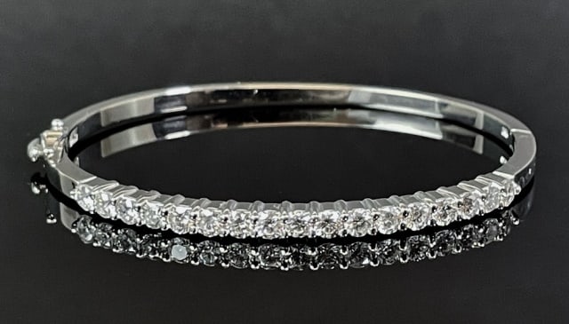 Ladies 14K Gold, Diamond Bangle Bracelet: Ladies 14K Gold and Diamond Bangle Bracelet. Crafted of 14K white gold, set with seventeen round modern brilliant cut natural diamonds, total weight of approximately 2.00 Cts. Diamonds are of excellen