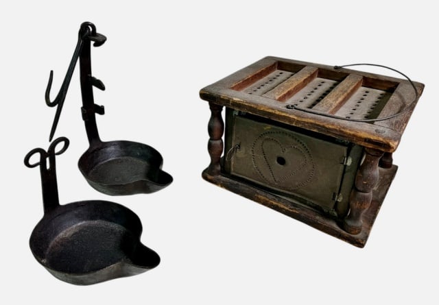 18th C Wrought Iron Betty Lamps, Foot Warmer (3pc): 18th C. Wrought Iron Betty Lamps and Foot Warmer. (2) Fitted iron "Betty" lamps with attachment pin, (1) Wood framed pierced tin foot warmer with heart decoration and bail handle. Foot warmer measures