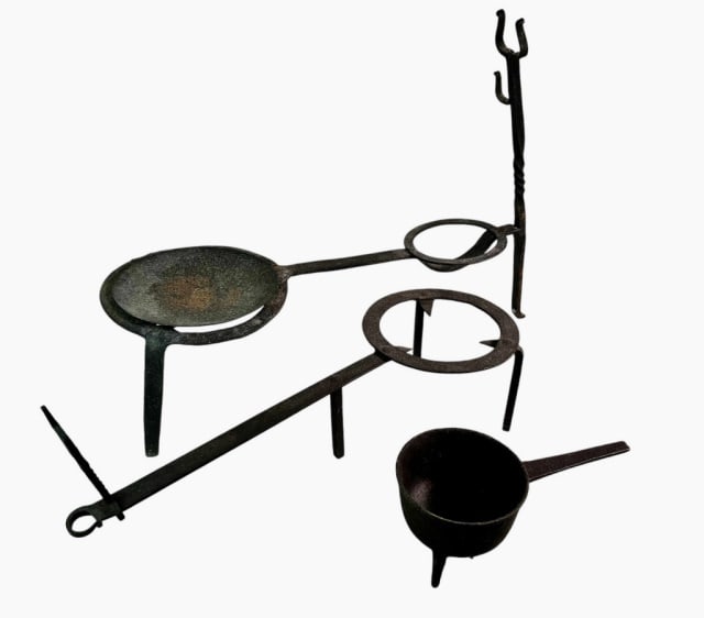 18th C. Wrought Iron Trivets and Tripod Pot (3pc): 18th C. Wrought Iron Trivets and Tripod Pot: (1) Three footed large trivet with plate and two braces, (1) Three-footed trivet, (1) Tripod cauldron. Good condition with old oxidation, largest measures: