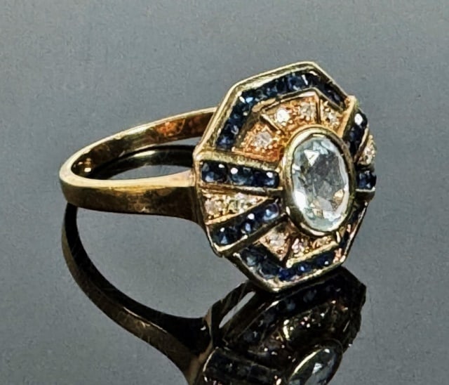 14K Gold Diamond and Sapphire Ring: 14K Gold Sapphire and Diamond Ring. 14K yellow gold set with round cut diamonds and sapphires with center bezel set oval cut white sapphire. Weight: 3.0 dwts, Size: 9