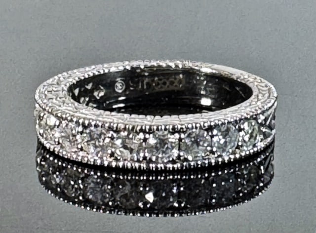 14K Gold Diamond Eternity Band Ring: 14K Gold Diamond Eternity Band. Crafted of 14K white gold channel set with thirteen well matched round cut diamonds. Good condition, total assembled weight: 4.0 Dwts, Size 5.5.
