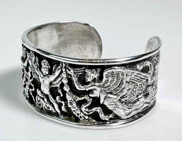 Antique Neoclassical Sterling Silver Bracelet: Antique Neoclassical Sterling Silver Bracelet. Cuff form with repousse winged angel decoration. Good condition, measures: 2.25" W, Weight: 2.32 Ozt.
