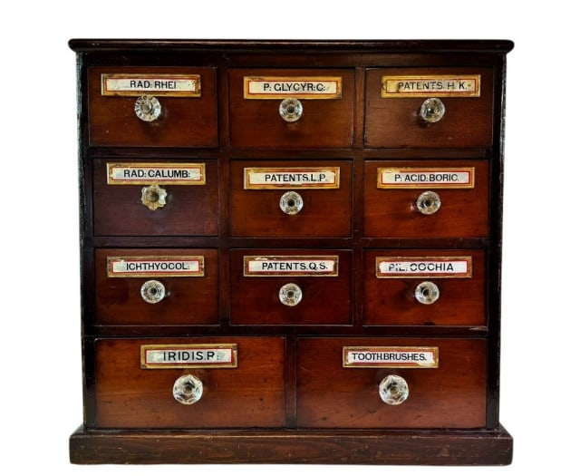 19th C Labeled Mahogany Apothecary Chest: 19th C. Label Under Glass Mahogany Apothecary Chest. Case with eleven fitted dovetailed drawers, nine over two with foil labels under glass and pressed glass pulls. Good condition, measures: 24" H x 2
