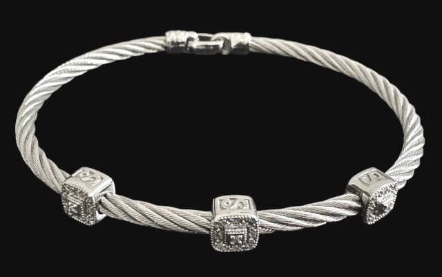 18K Gold, Steel and Diamond Bracelet, Chariol: 18K Gold, Steel and Diamond Bracelet, Signed "CHARIOL". Steel cable body with 18K gold beads set with three small round cut diamonds. Good condition, assembled weight: 6.25 Dwts.