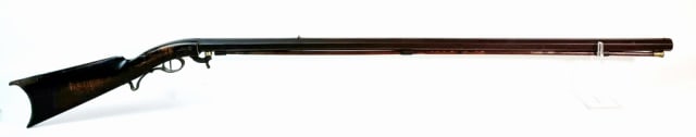 19th C. American Under Hammer Target Rifle: 19th C. Percussion Under Hammer Target Rifle. Carved walnut quarter stock with octagonal barrel and under hammer percussion action. Brass and steel furniture. Good condition, stock repaired at wrist,