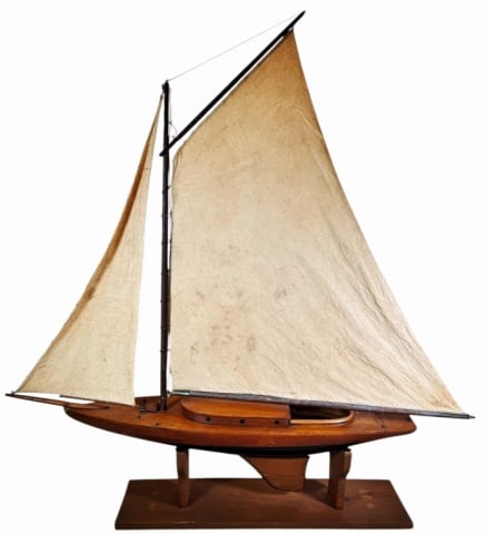 Antique Catboat Wooden Pond Boat: Antique Scratch Built Wooden Catboat Style Pond Boat. Carved wooden hull with mast forward and gaff rigged mainsail, rigged cloth sails. Good condition, repaired skeg, measures: 43.5" H x 40" W x 7" D