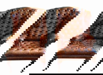 Pair of Leather Tufted Wingback Chairs (2pc): Pair of Tufted Leather Wingback Chairs. Brown leather upholstery with brass tacked trim and carved wooden feet. Good condition with wear, measure: 46" H x 29" W x 38" D