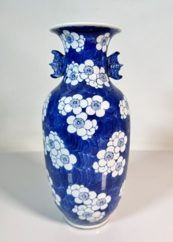 Chinese Qing Dynasty Porcelain Prunis Vase: Chinese Qing Dynasty Porcelain Prunis Vase. Vase with stylized ears at neck, hand decorated with prunis blossoms in blue and white, base with double ring. Good condition, measures: 9.75" H x 4" W