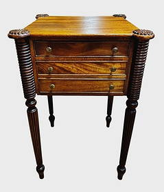 19th C. Mahogany Sheraton Stand: 19th C. American Sheraton Mahogany Stand. Case with three dovetailed drawers with period brass pulls. Ring turned and carved tapered legs with wooden rosette through top. Good condition with wear, mea