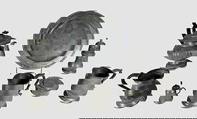 18th - 19th C. English, American Pewter (8pc): Collection of Eight Antique 18th - 19th C. English and American Pewter: (1) Teapot, (3) Tankard cups, (1) platter, (1) Traveling inkwell, (1) Whale oil chamber lamp, and (1) Muffineer. Pieces come fro