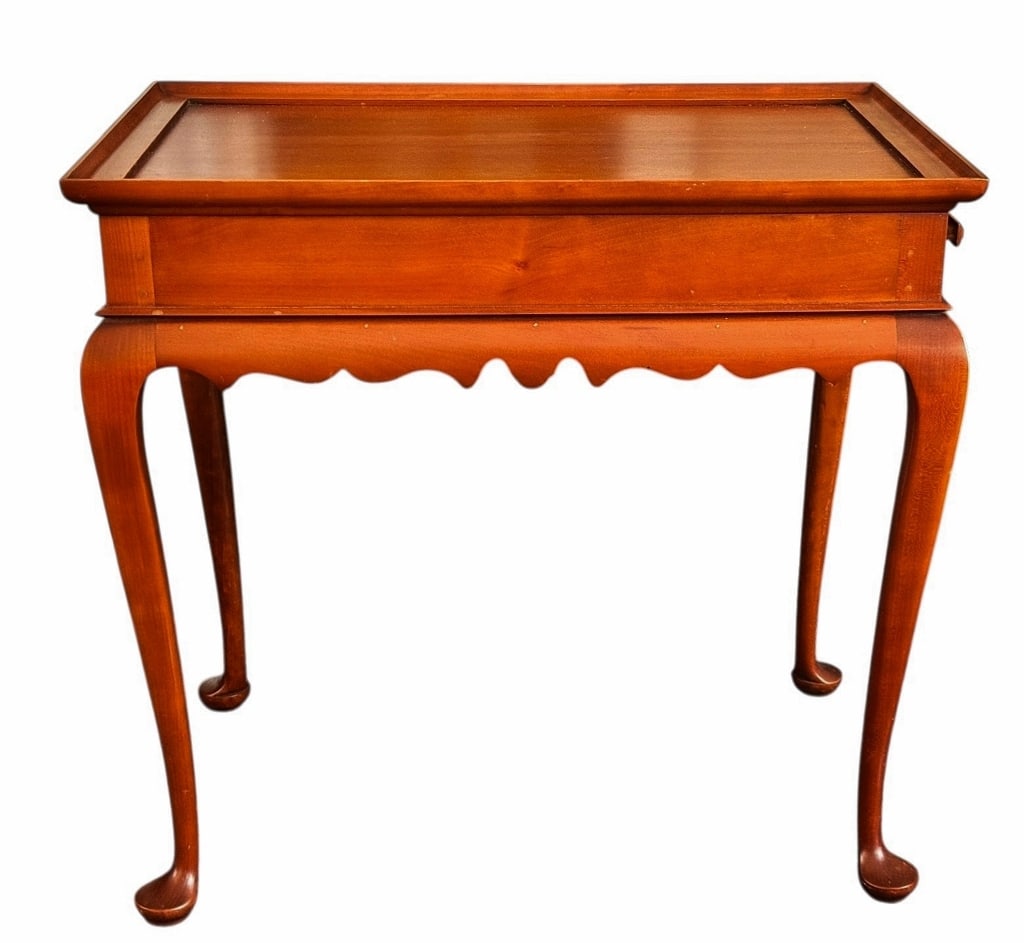 Queen Anne Cherry Tea Table, Eldred Wheeler: Contemporary Queen Anne Style Tea Table, Signed "ELDRED WHEELER". Crafted of cherry wood with carved Queen Anne legs and skirt with galleried top and two retractable sliding shelves. Good condition wi