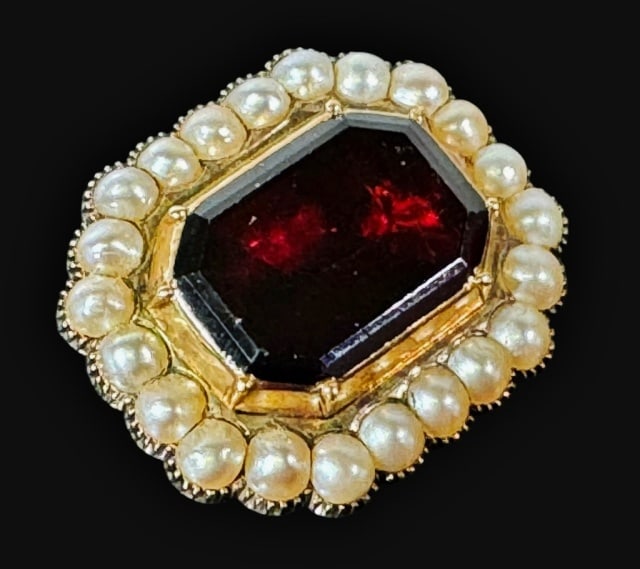 Antique 14K Gold Garnet and Pearl Brooch: Antique 14K Gold, Garnet and Pearl Brooch. Crafted of 14K yellow gold with center bezel set cut garnet of excellent quality surrounded with twenty-two small well matched saltwater pearls. Good conditi