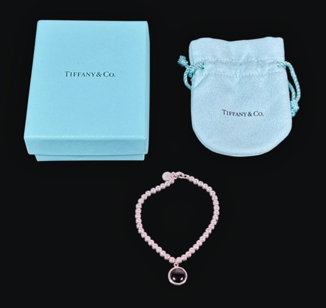 Sterling Silver Onyx Bracelet, Tiffany & Co: Vintage Sterling Silver Bracelet with Onyx Charm, Signed "TIFFANY & Co". Linked BB style bracelet with onyx cabouchon charm and tag artist signed "Paloma Picasso". Bracelet accompanied by Tiffany & Co