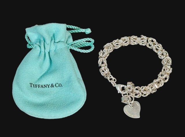 Vintage Sterling Silver Bracelet, Tiffany & Co: Sterling Silver Link Chain Bracelet with Heart Pendant, Signed "TIFFANY & CO." Bracelet with multiple interlocked links with lobster claw finding with single heart shaped charm. Bracelet accompanied b