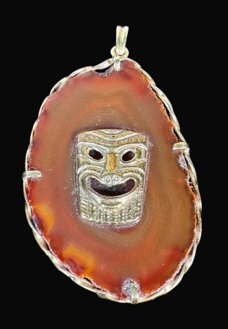 Italian 14K Gold Rimmed Agate Slice Pendant: Italian 14K Gold Rimmed Agate Slice Pendant. Large, translucent orange agate framed by a 14K yellow gold twisted border. Center with pinned 14K gold classical Greek comedic mask. Measures: 2.75" L, to