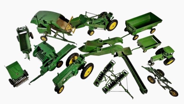 Collection 1960's John Deere Tractor Toys (12pc): Collection of 1960's John Deere Tractor Toys. Detailed die cast metal toys modeled after John Deere tractors and harvesting machinery with moving parts. Good condition, largest measures: 13" L