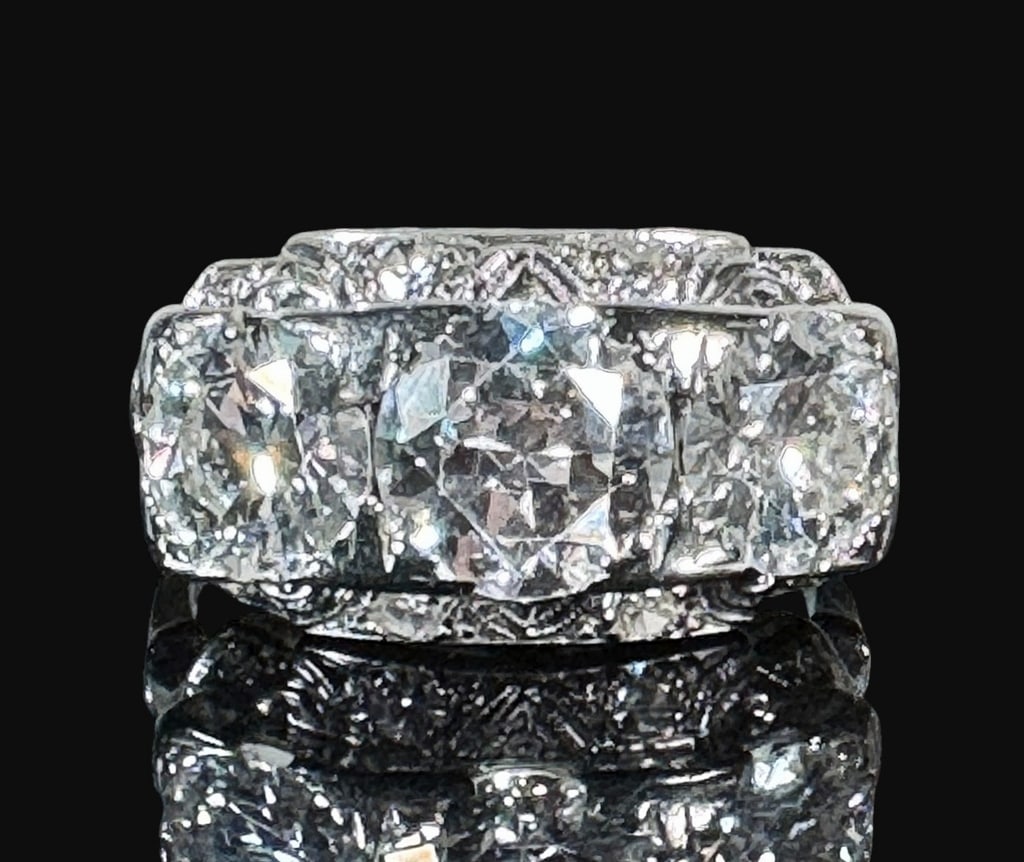 18K Gold Art Deco Diamond Ring: Art Deco 18K Gold and Diamond Ring, Signed "JABEL". White gold ring with large, ornate horizontal gallery set with three large round transitional cut diamonds and ten small round diamond surround. Lar