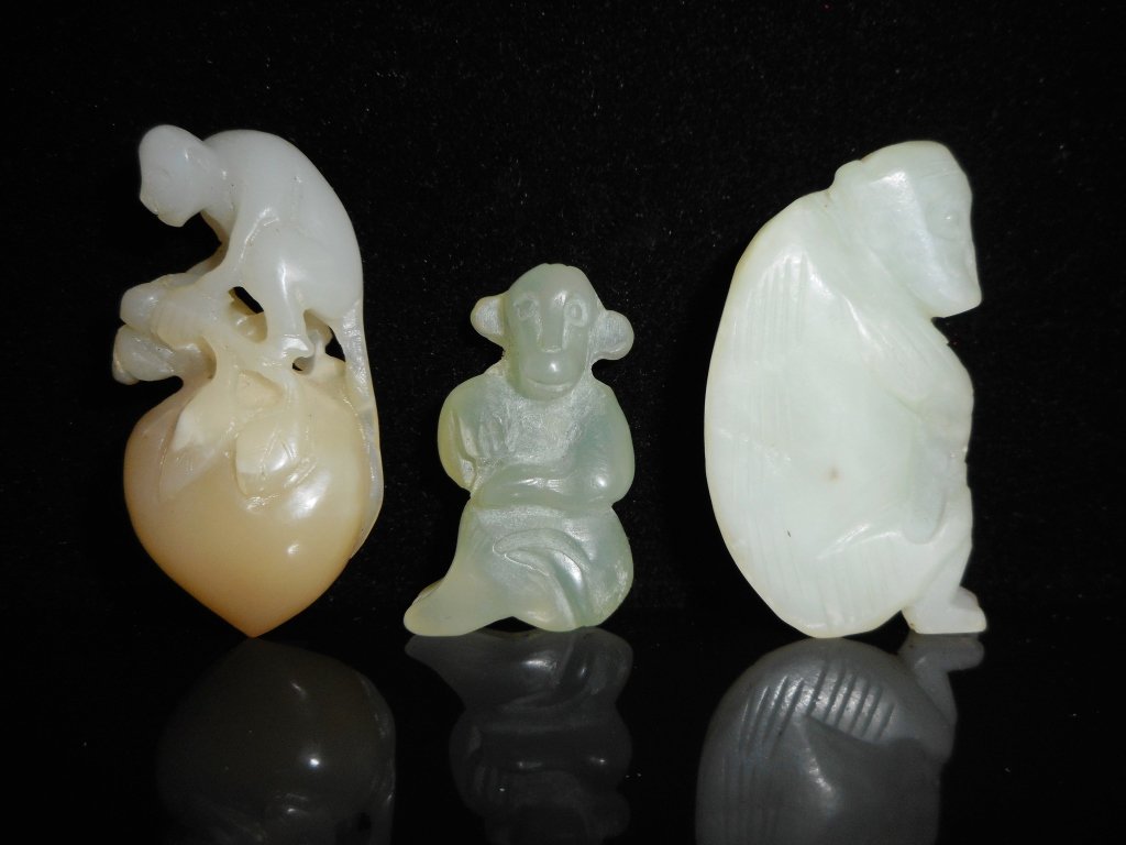 Three White Jade Monkey Figures: Three white jade carvings in the form of a monkey._x000D_ One greenish-white carving of a monkey scratching his head with smooth polished finish and one small dark colored suffusion on front. 2"H_x000