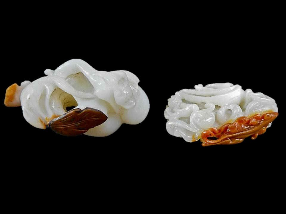 Two Jade Naturalistic Figures: Two white jade openwork carvings depict woodland creatures, lizards, flora and fruit accentuated by the natural color variations in the stone. Each having smooth polished surfaces with incised details