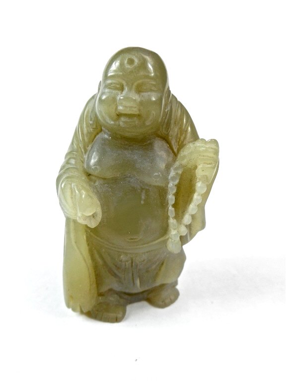 Jade Standing Buddha: Green-white jade carving of a standing Buddha with a smooth polished surface and incised details. There is an area of russet and white suffusion and veining on reverse. Qing Dynasty (1644 - 1912), fro