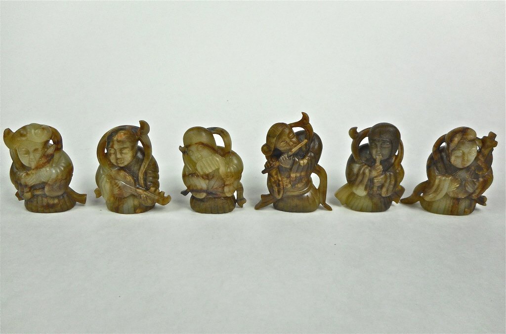 Six Jade Musicians: Collection of six openwork musicians in green jade, having smooth polished surfaces with mahogany or brown colored suffusion and veining with areas of erosion. 2"H