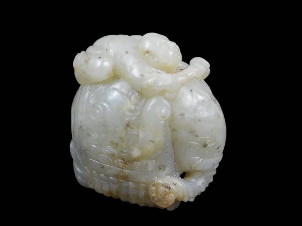 Jade Elephant and Rider Figure: Grey-white jade rendition of an elephant with a rider holding a scepter. Smooth surface with incised details and cloud design on elephant. Brown and slight russet suffusion. 2"H