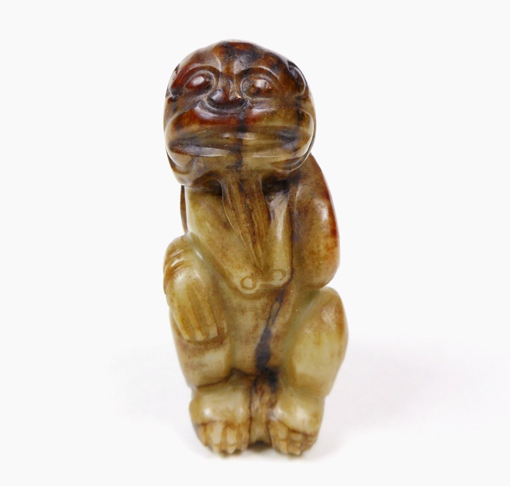 Jade Mythological Beast Figure: Jade carving of a mythological beast with female attributes. Smooth surface with incised details and well worn grooves. Deep russet and brown suffusion and veining. 2.25"H
